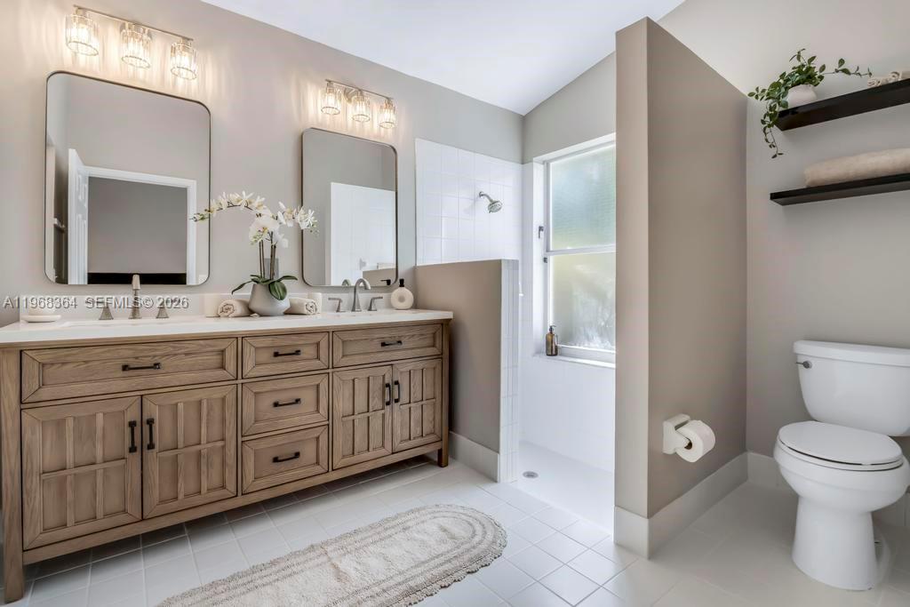 2972 Southwest 174th Avenue Miramar, FL 33029 - Photo 23 of 55 a spacious bathroom with a double vanity sink a mirror and a toilet