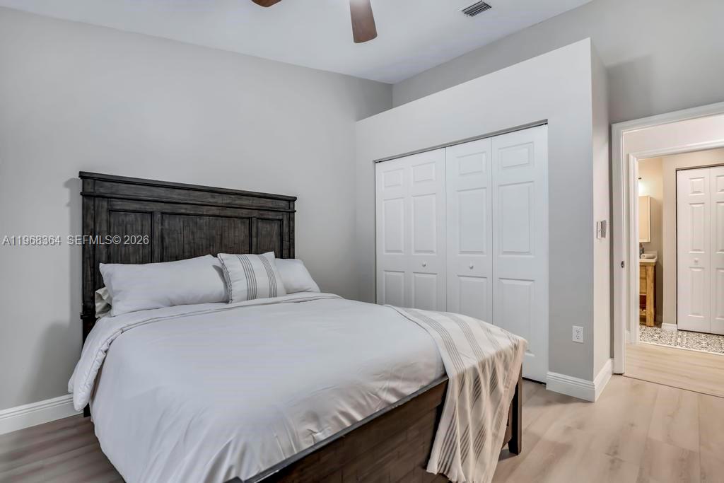 2972 Southwest 174th Avenue Miramar, FL 33029 - Photo 28 of 55 a bedroom with a bed and wooden floor