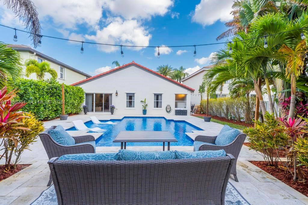 2972 Southwest 174th Avenue Miramar, FL 33029 - Photo 35 of 55 a view of house with swimming pool and sitting area