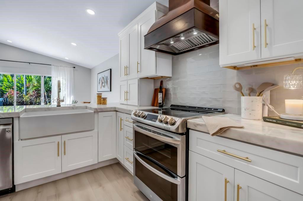 2972 Southwest 174th Avenue Miramar, FL 33029 - Photo 8 of 55 a kitchen with stainless steel appliances granite countertop a stove and a sink