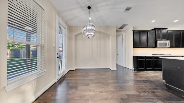 a view of kitchen with granite countertop window and stainless steel appliances
