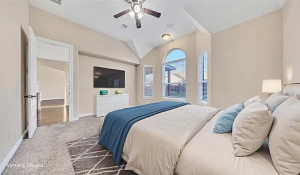 a bedroom with a bed and a flat screen tv