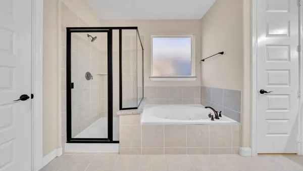 a bathroom with a bathtub and a shower