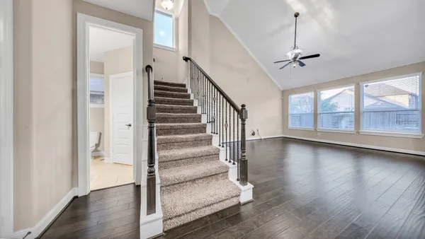 a view of entryway and hall with wooden floor