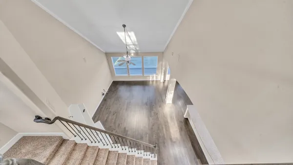 a view of a livingroom with a ceiling fan and window