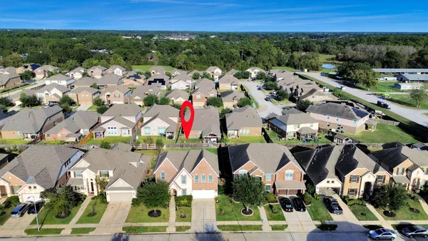 an aerial view of residential house with outdoor space and swimming pool