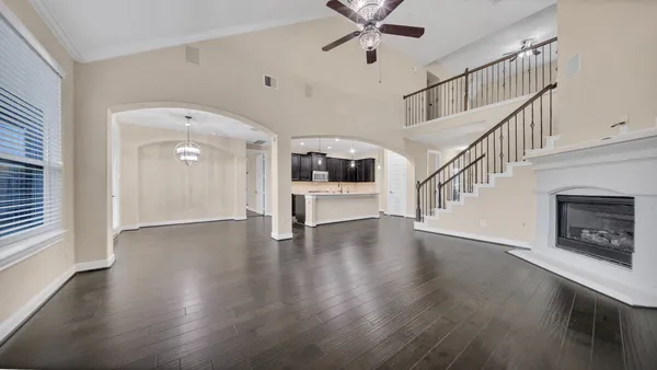 a view of an entryway with wooden floor and a kitchen