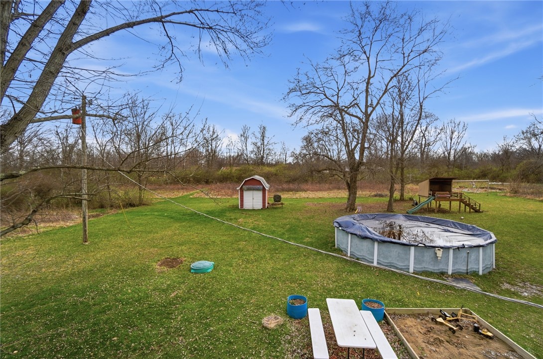 290 Ginghamsburg Road Tipp City, OH 45371 - Photo 42 of 49 This spacious yard offers a shed, above ground pool, and ample room for outdoor activities.