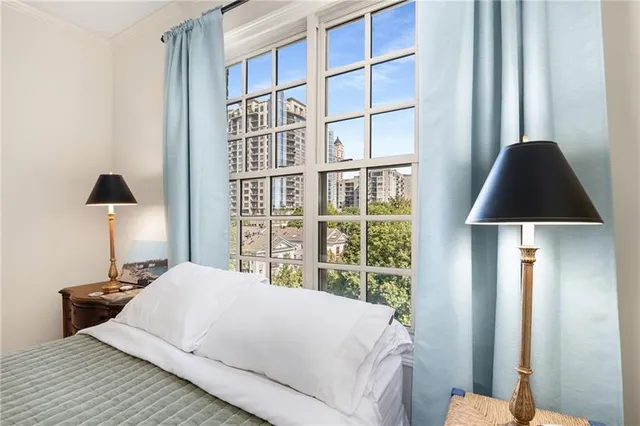 a bedroom with a bed and a lamp on table