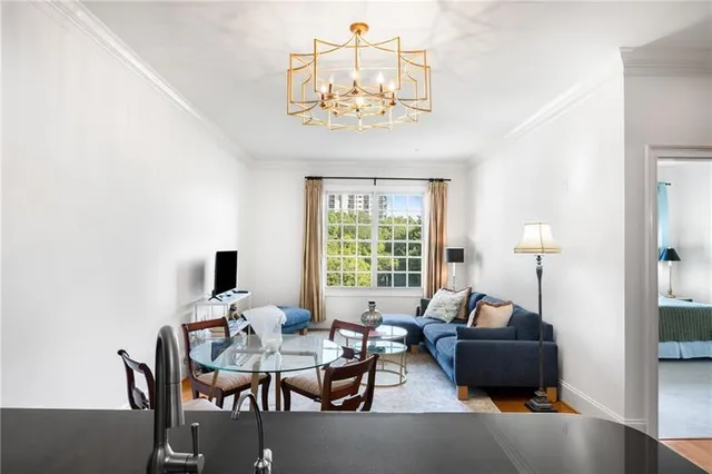a living room with furniture and a chandelier