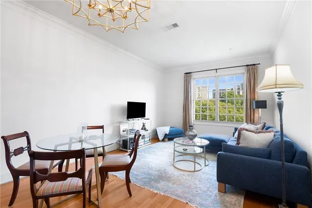 a living room with furniture a flat screen tv and a large window
