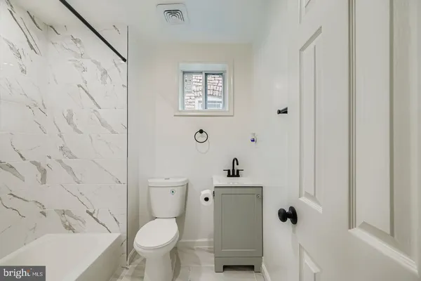 a white toilet sitting next to a bathroom sink