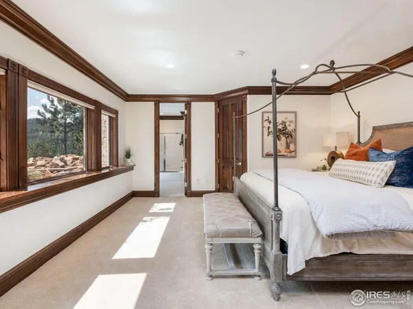 a bedroom with a bed and large window with outer view