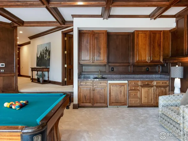 a kitchen with granite countertop a stove a sink and a microwave