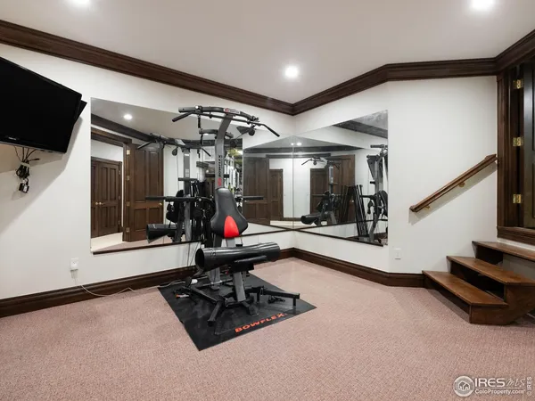 a room with gym equipment and a flat screen tv