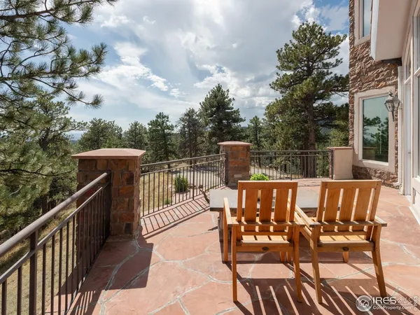 a view of a balcony with wooden floor and outdoor seating