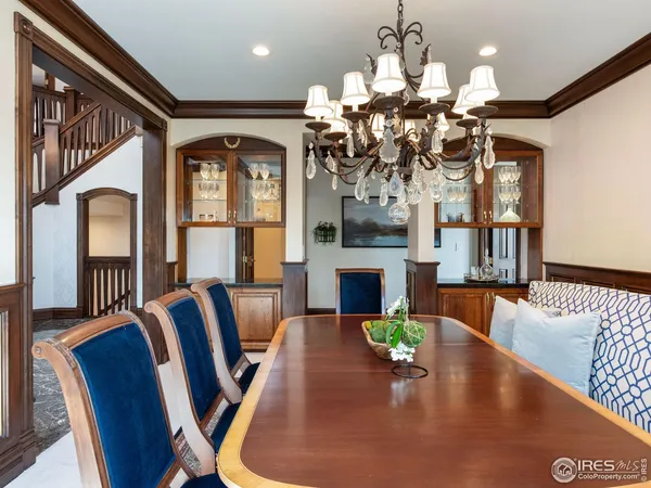 a view of a dining room with furniture a chandelier and wooden floor