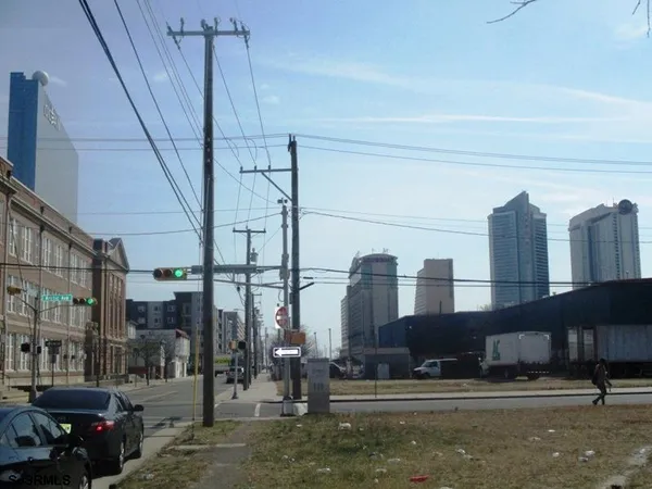a city street with tall buildings and cars parked on the street