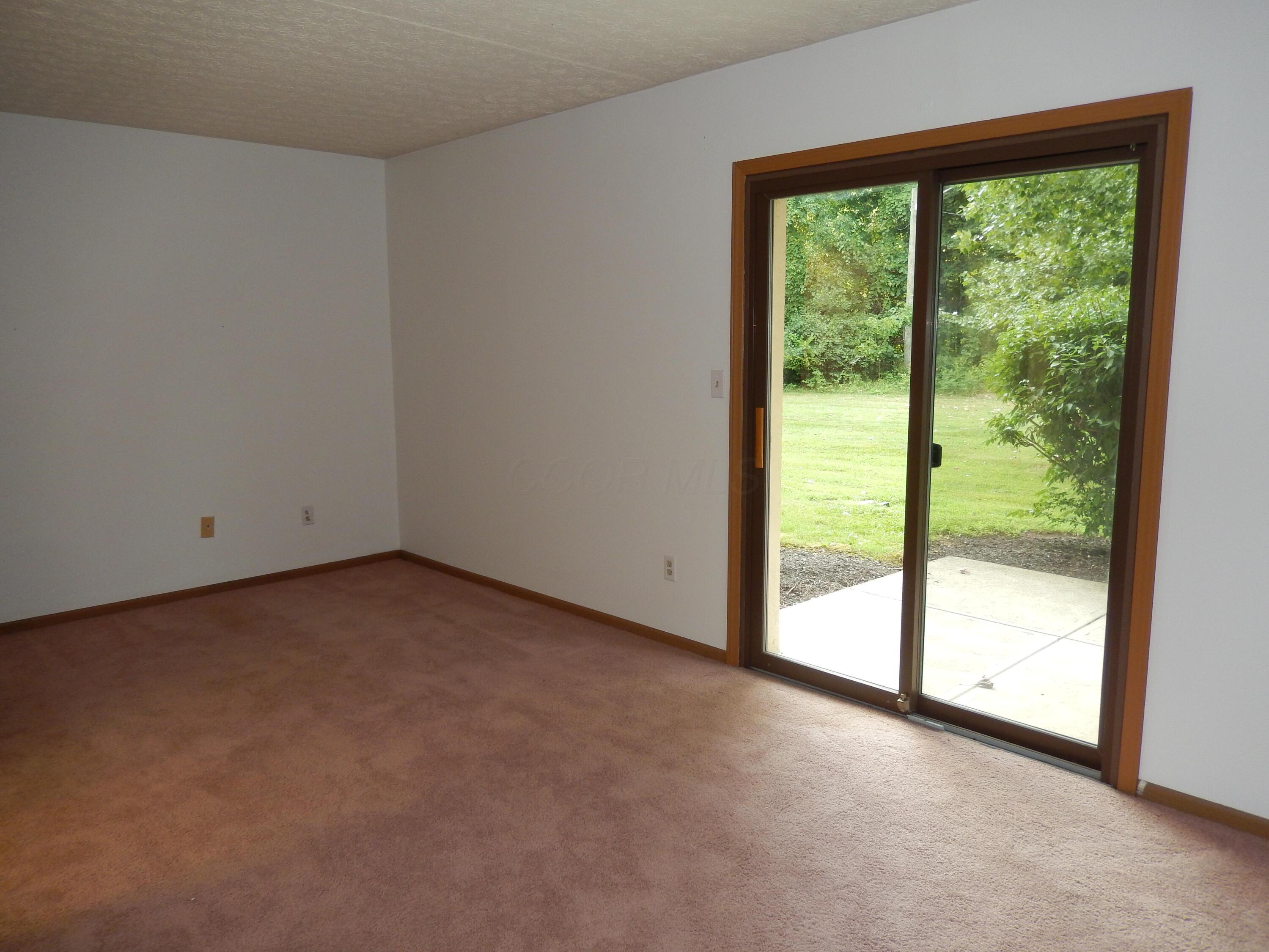 3939 Karl Road, Unit 122 Columbus, OH 43224 - Photo 29 of 57 Primary Bedroom with sliding door to covered patio