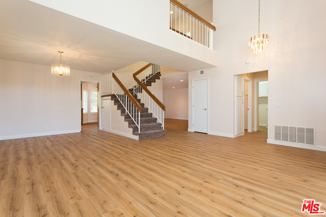 13639 Bear Valley Road Moorpark, CA 93021 - Photo 2 of 25 a view of an empty room with wooden floor and stairs