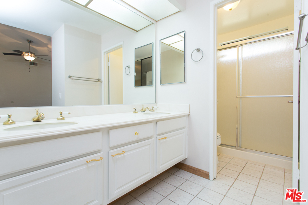 13639 Bear Valley Road Moorpark, CA 93021 - Photo 13 of 25 a bathroom with a double vanity sink and a mirror