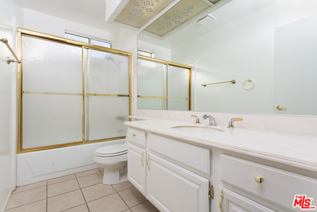 13639 Bear Valley Road Moorpark, CA 93021 - Photo 16 of 25 a bathroom with a granite countertop sink toilet and mirror