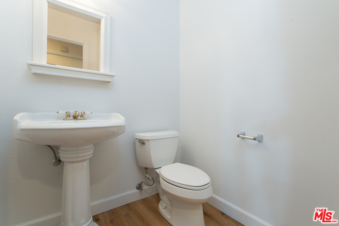 13639 Bear Valley Road Moorpark, CA 93021 - Photo 18 of 25 a bathroom with a sink a toilet and mirror