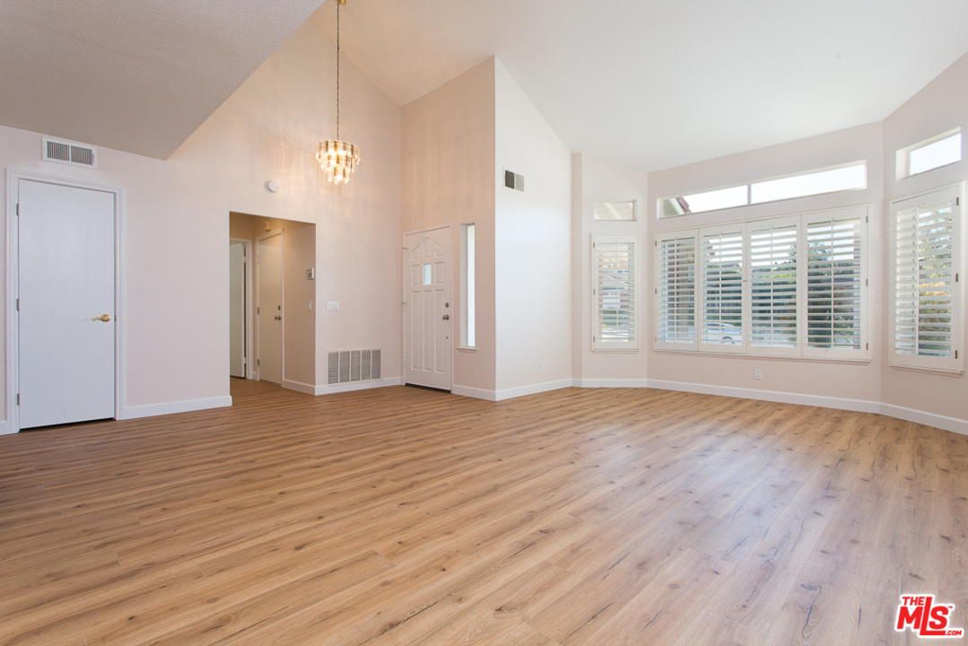 13639 Bear Valley Road Moorpark, CA 93021 - Photo 3 of 25 a view of an empty room with wooden floor and a window
