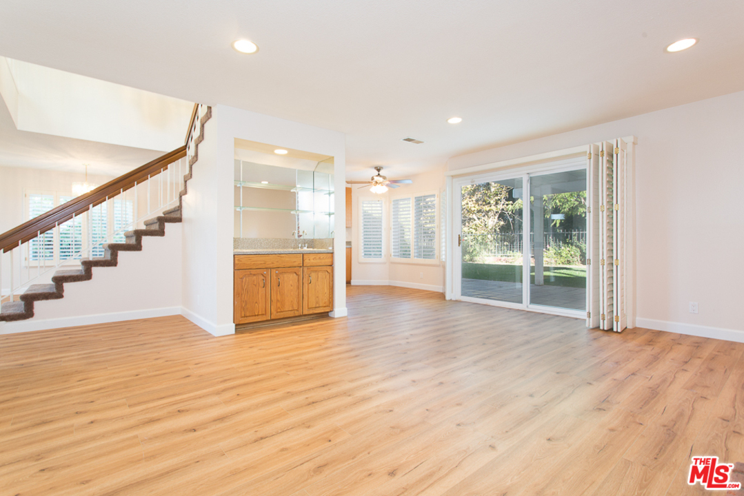 13639 Bear Valley Road Moorpark, CA 93021 - Photo 6 of 25 a view of an empty room with wooden floor and a window