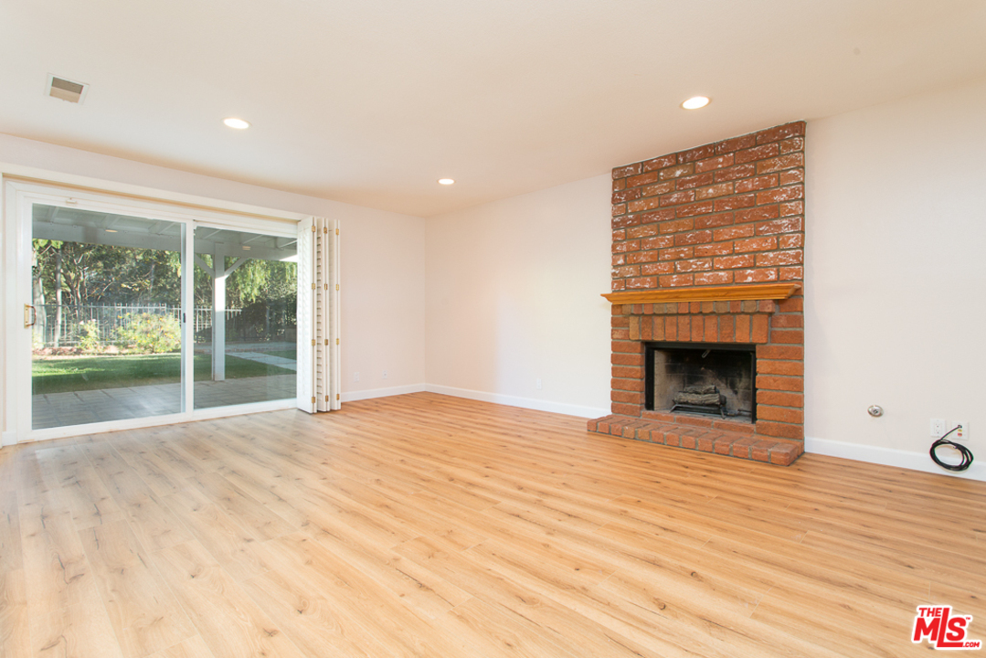 13639 Bear Valley Road Moorpark, CA 93021 - Photo 7 of 25 a view of an empty room with wooden floor and a window
