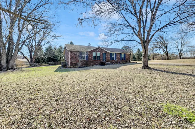 a view of house with a yard covered with snow in front of house