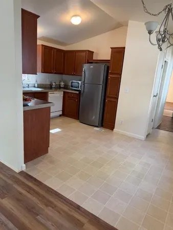 a kitchen with stainless steel appliances a refrigerator and a microwave