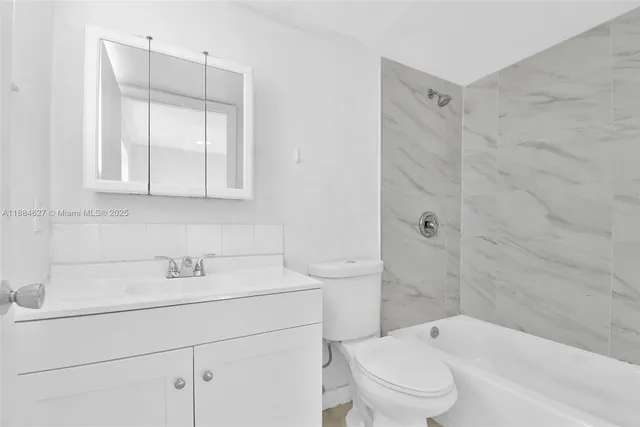 a bathroom with a sink toilet and vanity