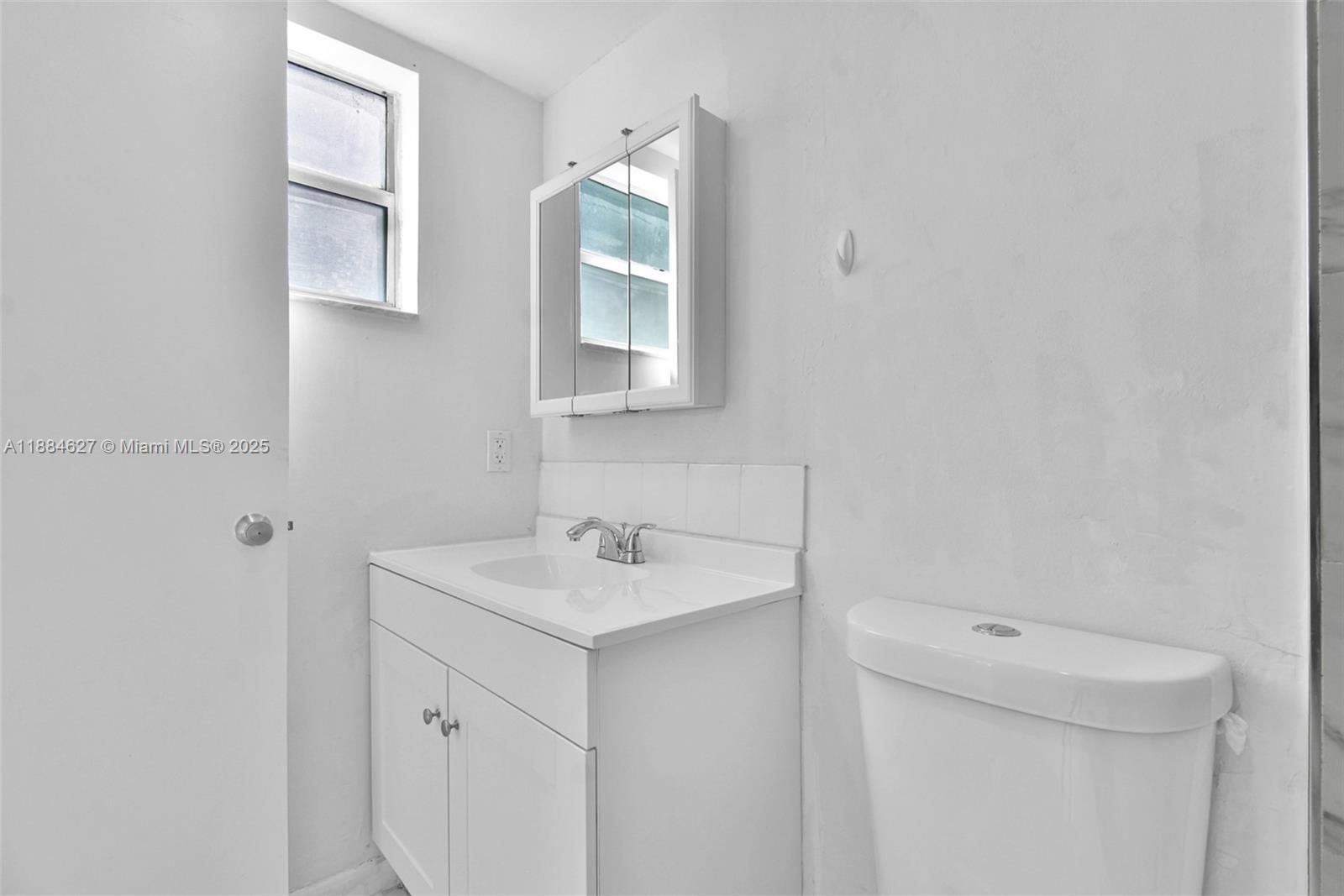 618 Euclid Avenue, Unit 303 Miami Beach, FL 33139 - Photo 13 of 26 a bathroom with a sink toilet and vanity
