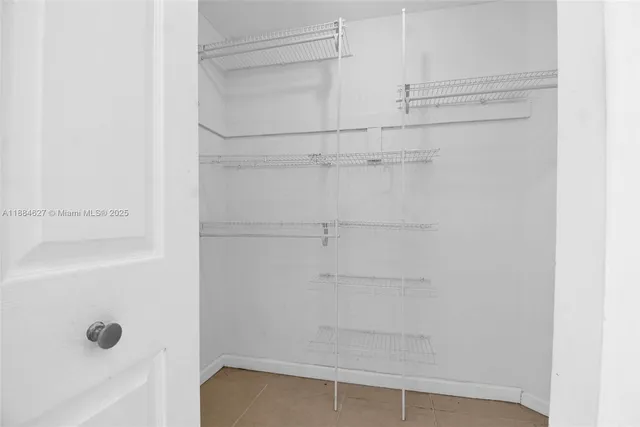 a view of washer and dryer with kitchen in the background