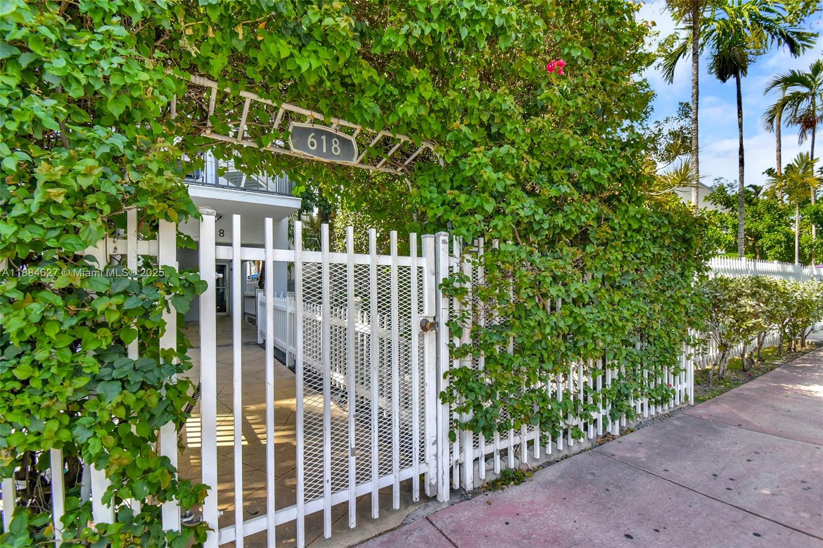 618 Euclid Avenue, Unit 303 Miami Beach, FL 33139 - Photo 24 of 26 a view of a house with a small yard and wooden fence