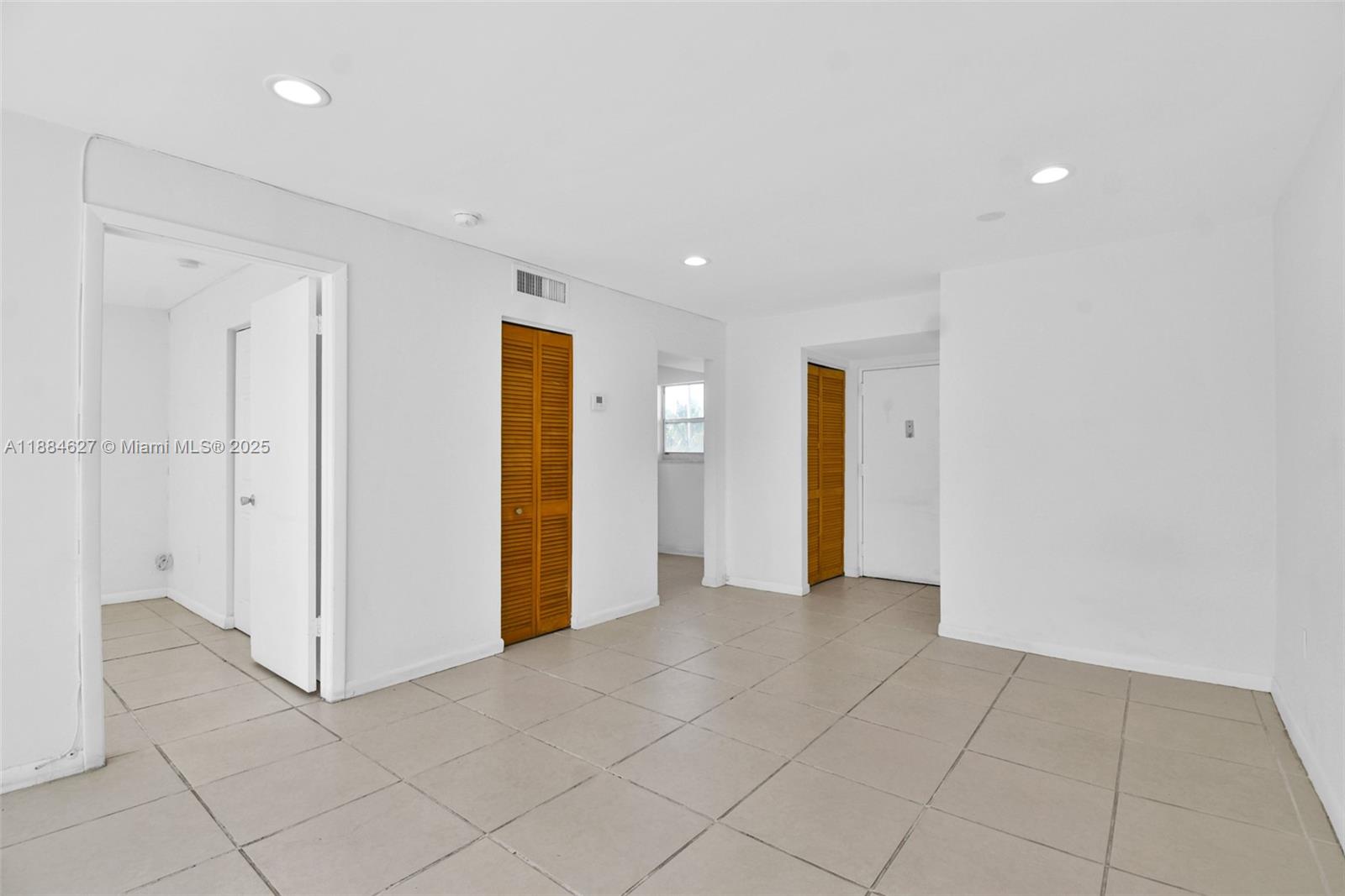 618 Euclid Avenue, Unit 303 Miami Beach, FL 33139 - Photo 3 of 26 an empty room with closet and mirrors