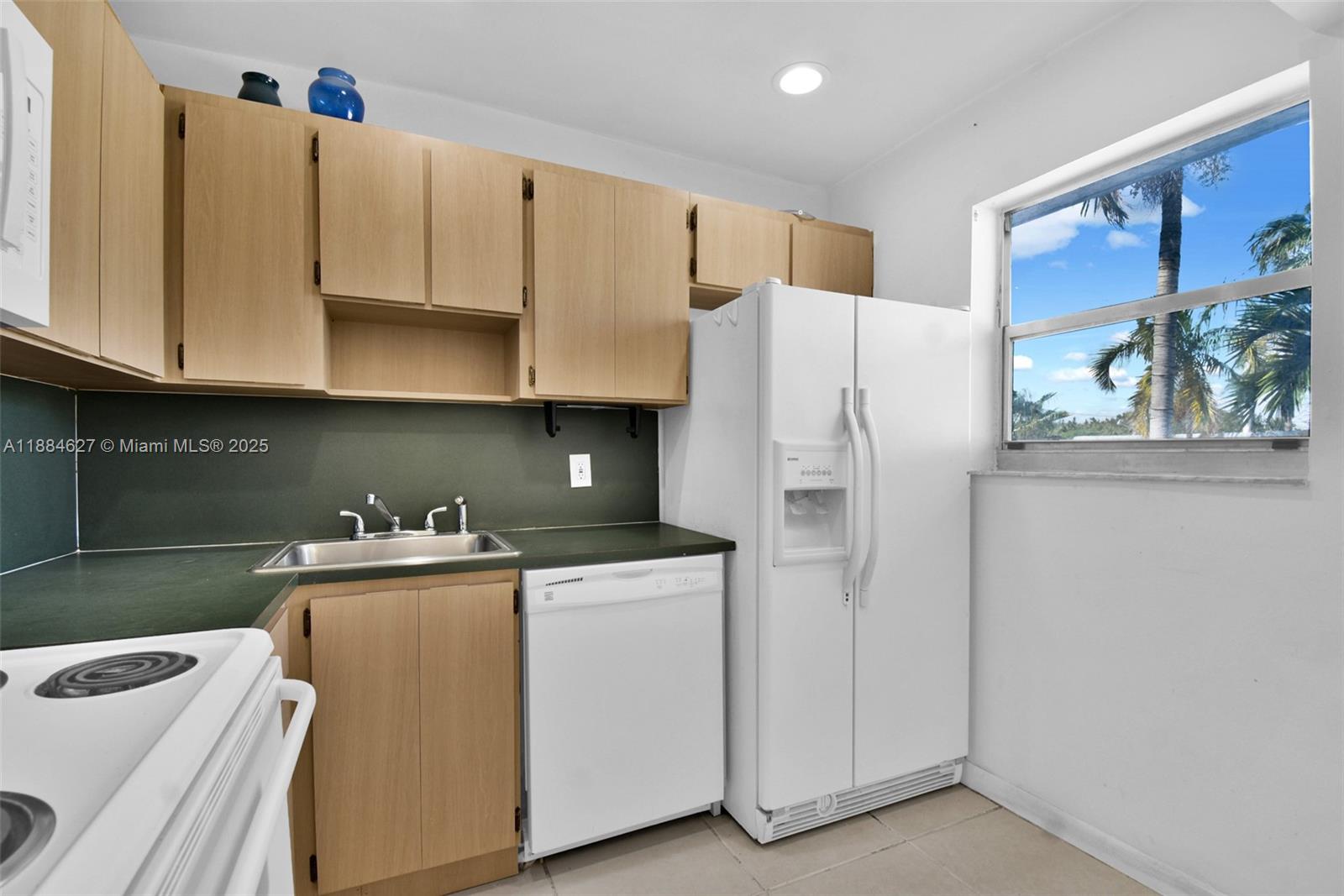 618 Euclid Avenue, Unit 303 Miami Beach, FL 33139 - Photo 5 of 26 a kitchen with stainless steel appliances a refrigerator sink and cabinets