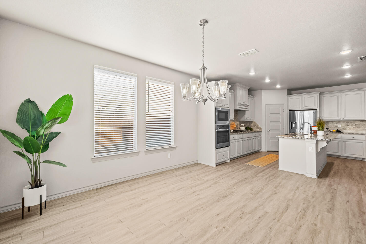 7613 61st Street Lubbock, TX 79407 - Photo 11 of 37 a view of a kitchen with microwave and refrigerator