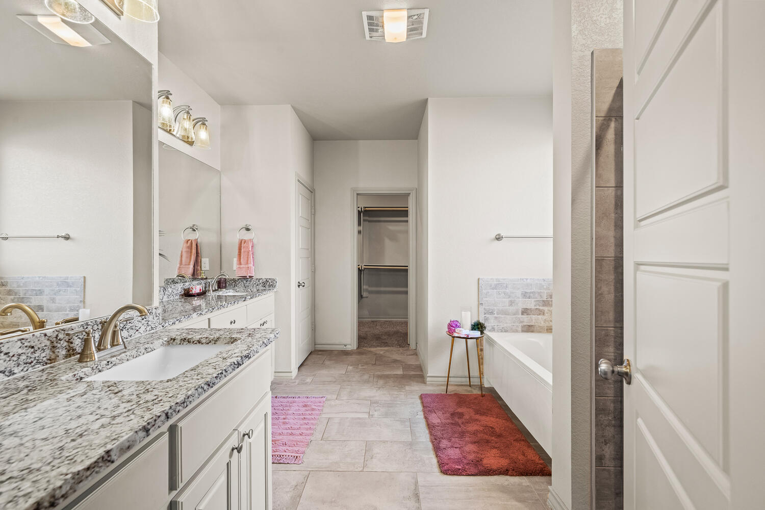 7613 61st Street Lubbock, TX 79407 - Photo 15 of 37 a bathroom with a granite countertop sink a mirror and a bathtub