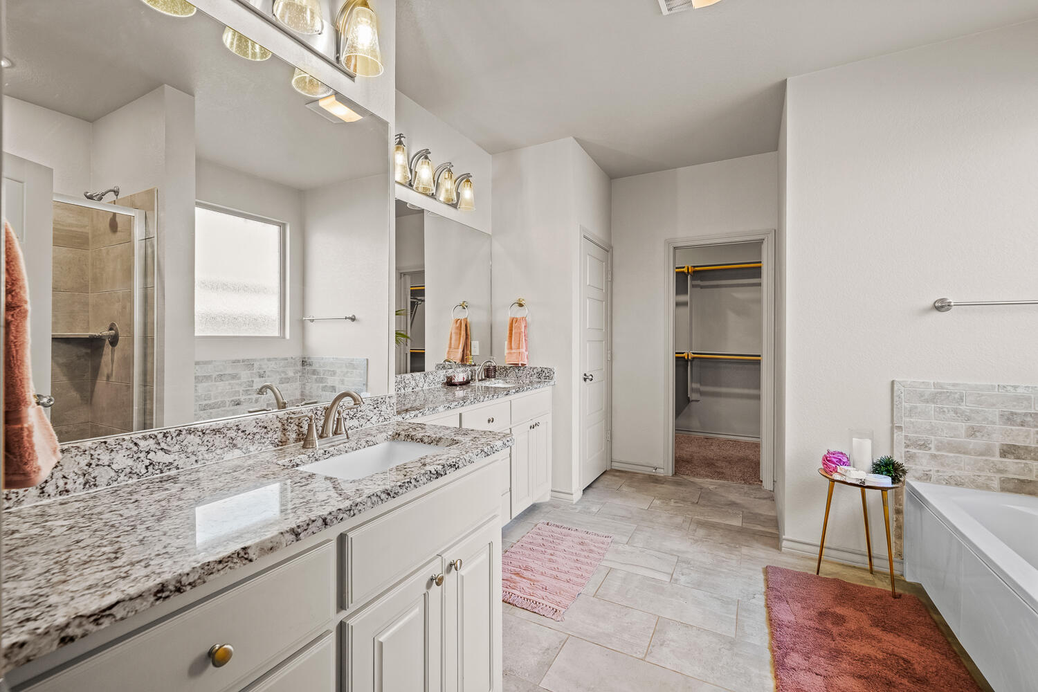 7613 61st Street Lubbock, TX 79407 - Photo 16 of 37 a spacious bathroom with a granite countertop sink and a mirror