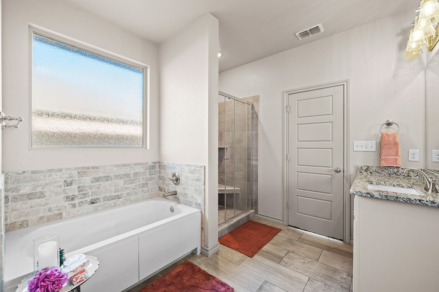 7613 61st Street Lubbock, TX 79407 - Photo 18 of 37 a bathroom with a granite countertop tub sink and mirror