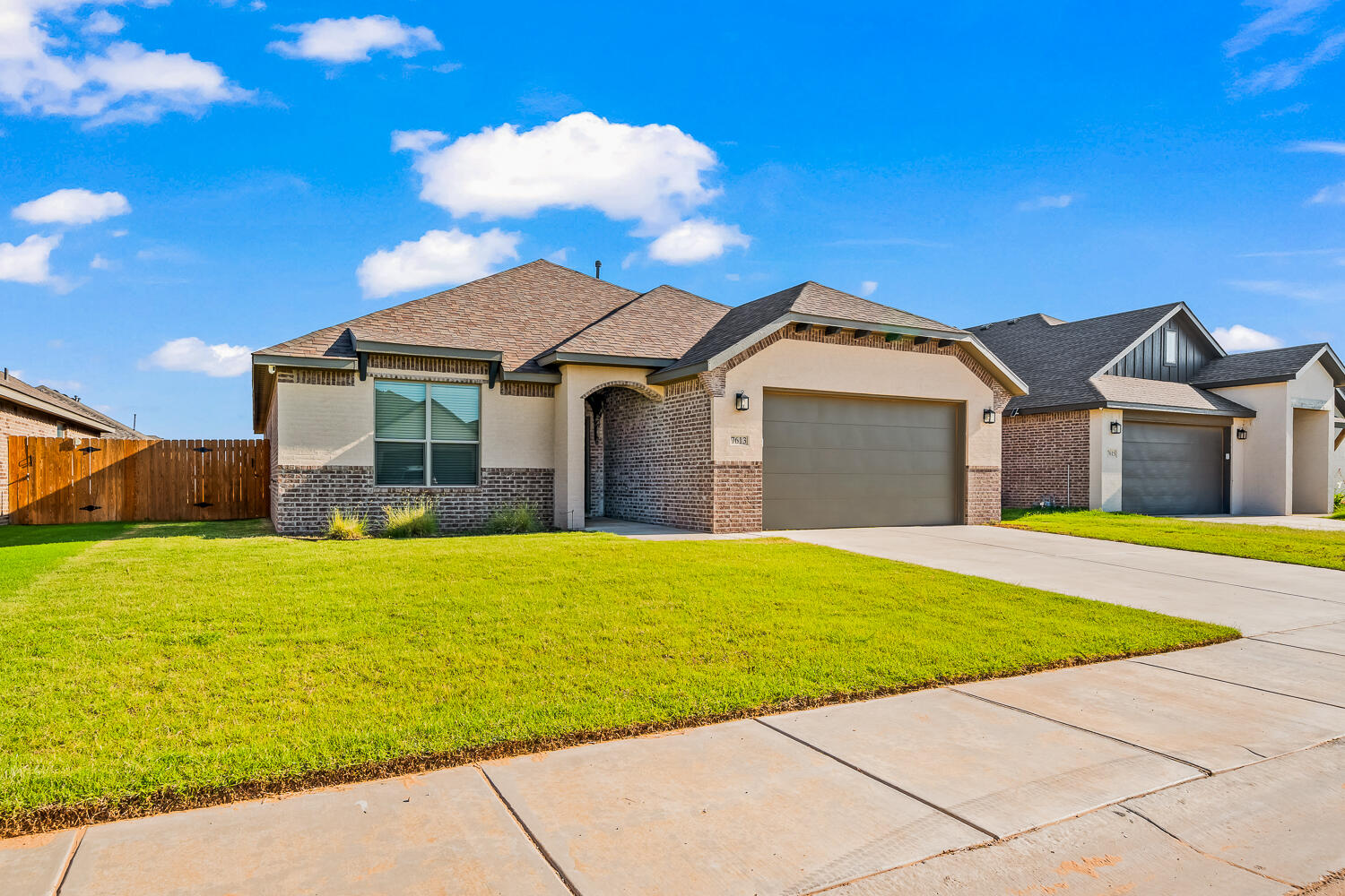7613 61st Street Lubbock, TX 79407 - Photo 2 of 37 a front view of a house with a garden
