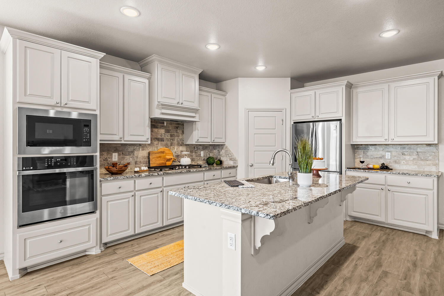 7613 61st Street Lubbock, TX 79407 - Photo 8 of 37 a kitchen with sink a microwave and cabinets