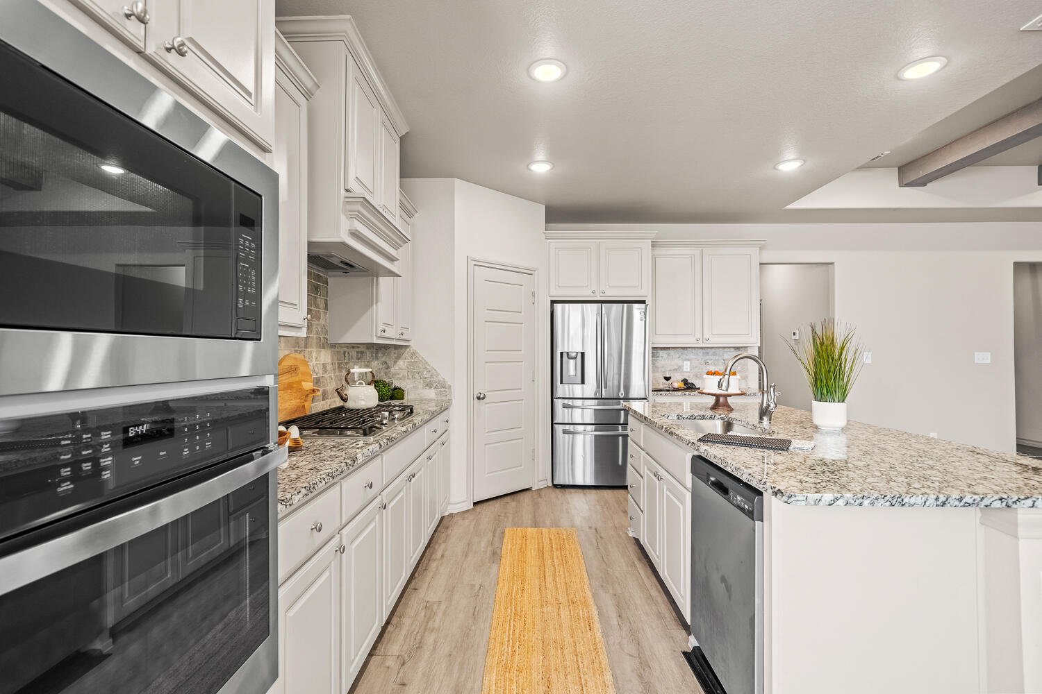 7613 61st Street Lubbock, TX 79407 - Photo 10 of 37 a kitchen with stainless steel appliances granite countertop a stove a sink and a refrigerator