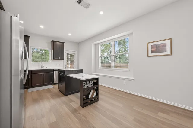 a kitchen with a sink appliances cabinets and furniture