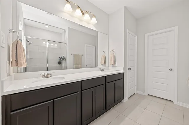 a bathroom with a double vanity sink and a mirror