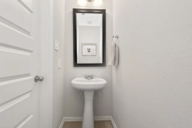a bathroom with a sink a mirror and shower