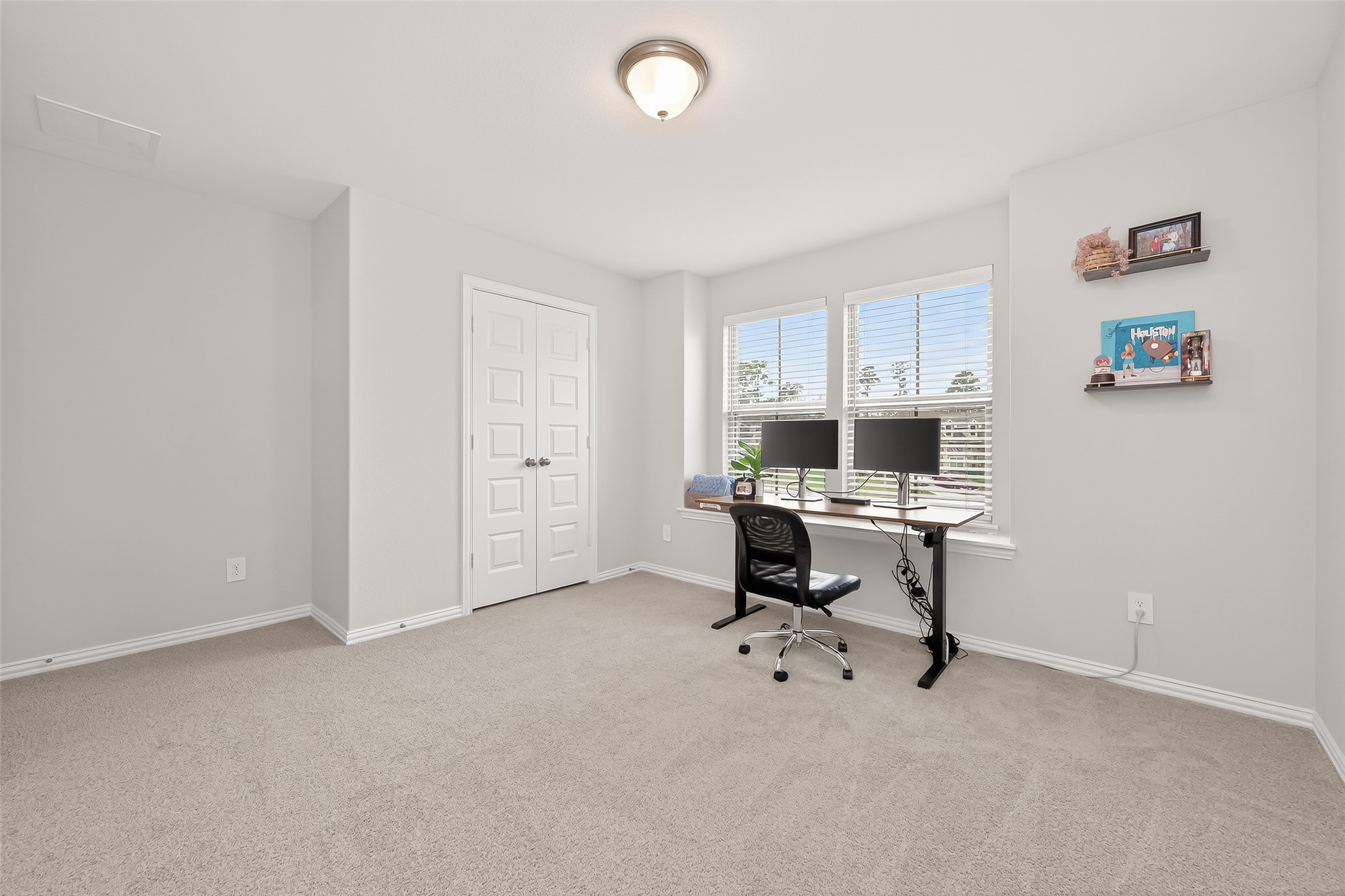218 Skybranch Court Conroe, TX 77304 - Photo 25 of 50 a view of a workspace with furniture and a window