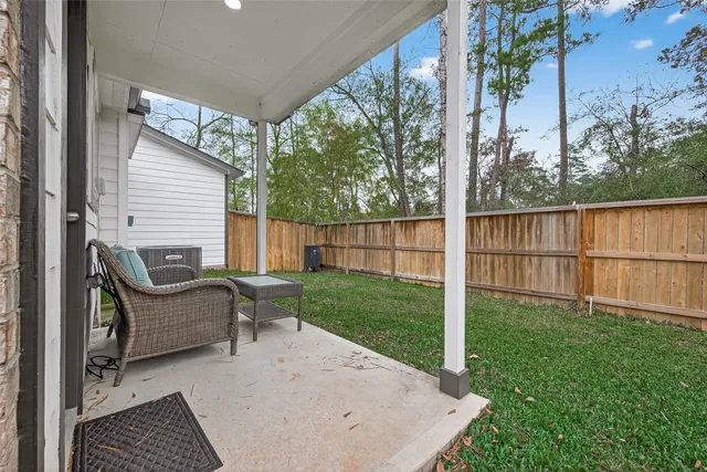 a view of a backyard with couches chair and grass